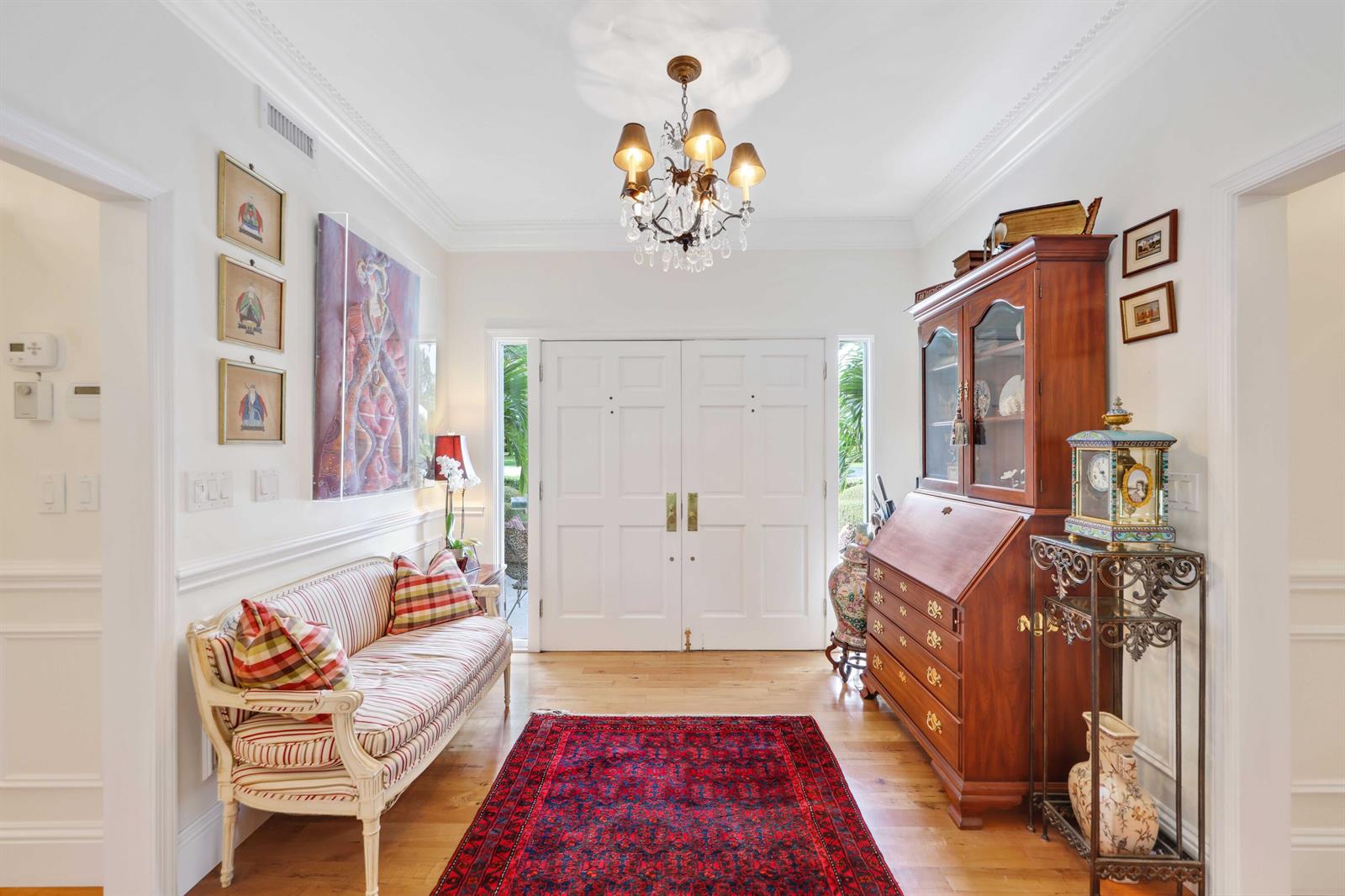 A foyer features a striped settee, a wooden secretary desk, and a red area rug — 36 Country Road, FL 33436, FL
