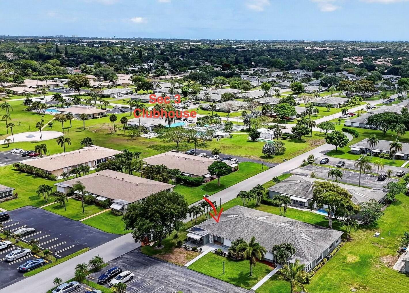 An aerial view shows a residential community with a clubhouse and a marked single-story home — 920 South Drive # A, Delray Beach FL 33445, DELRAY BEACH, FL
