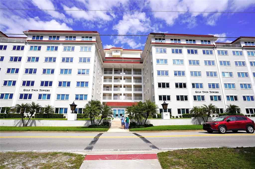 The exterior of the multi-story Gulf Twin Towers apartment building features white walls and balconies — 500 THE ESPLANADE N UNIT 604, VENICE, FL