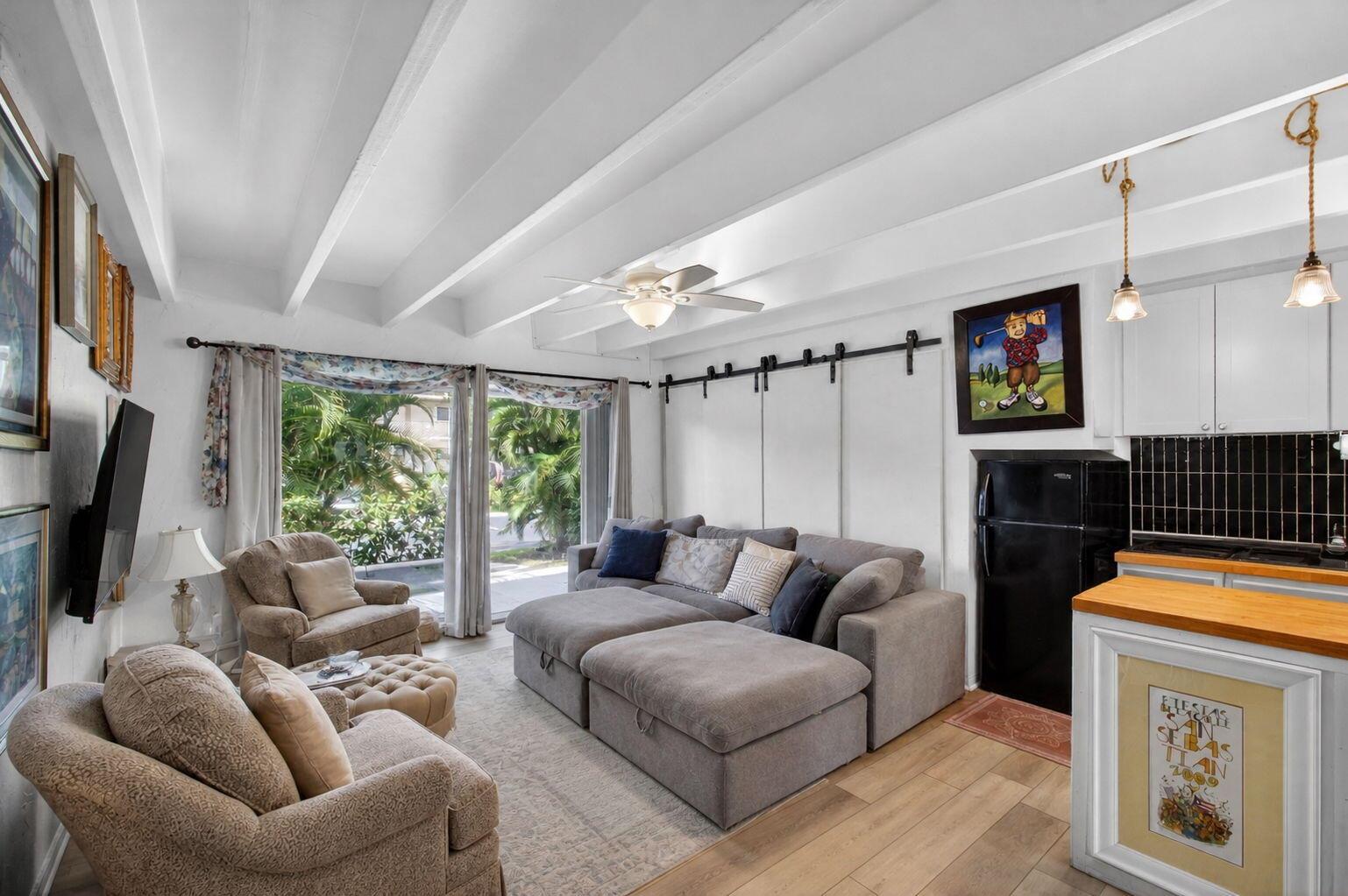 A living room features a grey sectional sofa, two armchairs, a ceiling fan, and kitchen area — 4001 S Ocean Boulevard # 111, Palm Beach FL 33480, PALM BEACH, FL