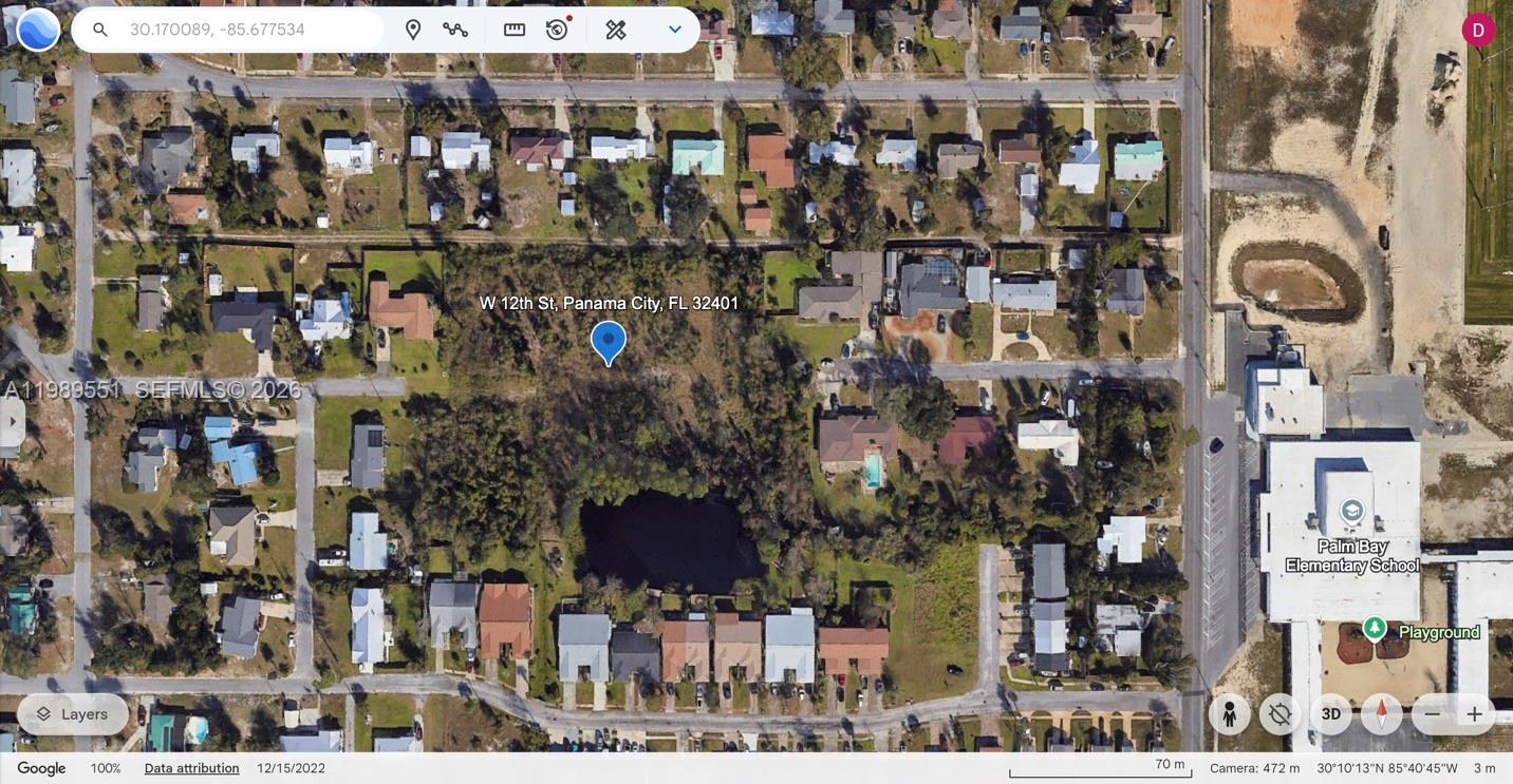 This is a satellite map view of a residential area featuring a wooded lot — W 12th St, Panama City FL 320401, PANAMA CITY, FL