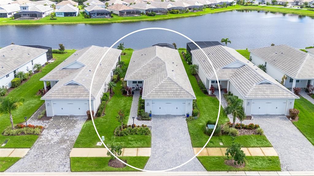 An aerial view shows a single-story suburban house with a white garage and tiled roof — 8152 STERNWAY ROAD, SARASOTA, FL