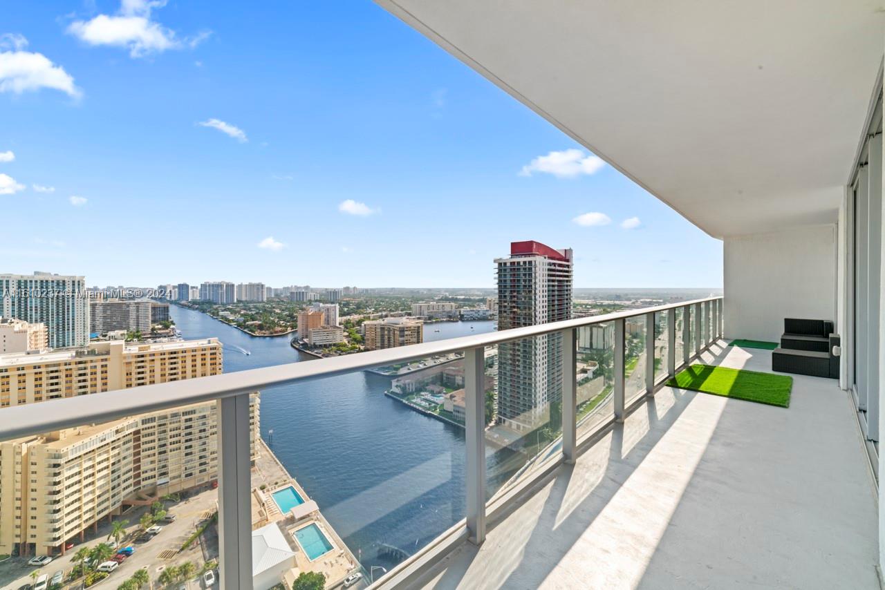 A high-rise balcony overlooks a river, city buildings, and a swimming pool below — 4010 S Ocean Dr # R2409, Hollywood FL 33019, HOLLYWOOD, FL