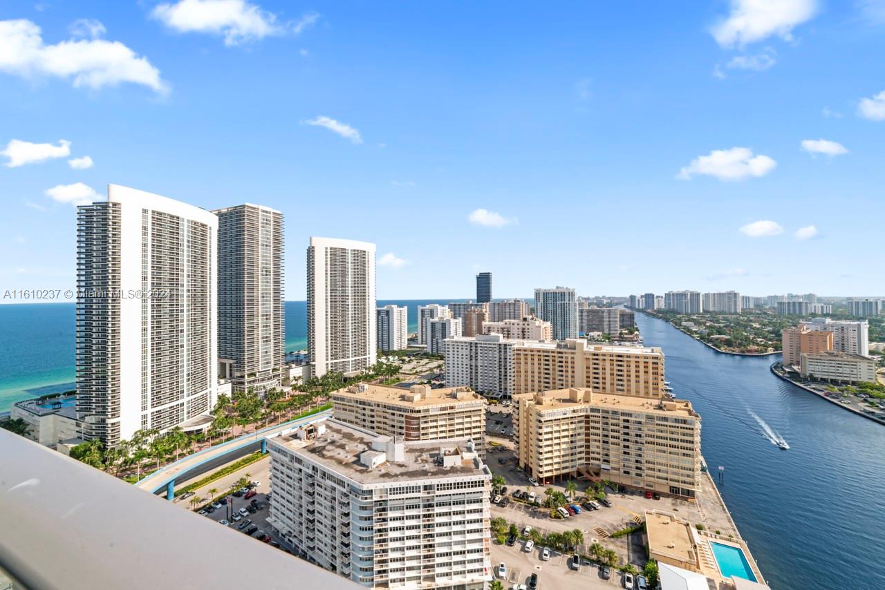 An elevated view of a coastal city featuring high-rise buildings, a waterway, and the ocean — 4010 S Ocean Dr # R2409, Hollywood FL 33019, HOLLYWOOD, FL