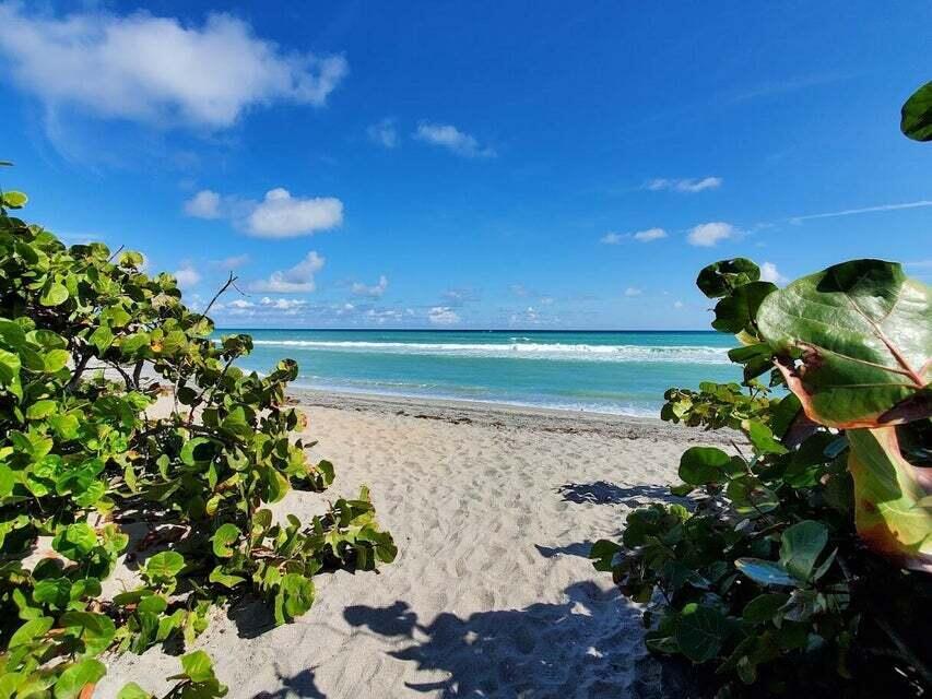 A sandy path leads through green foliage to a sunny beach and the ocean — 1605 S Us Highway 1 # F203, Jupiter FL 33477, JUPITER, FL