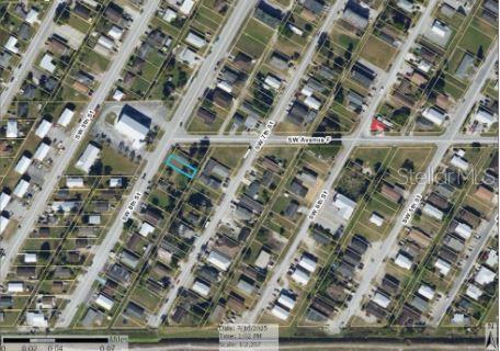 An aerial map view shows a rectangular vacant lot highlighted in blue within a residential neighborhood — 609 SW 8TH STREET UNIT 1, BELLE GLADE, FL