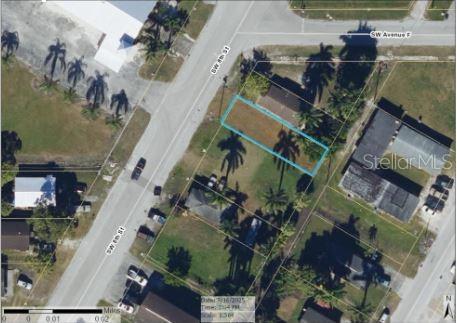 This is an aerial map view showing a rectangular property lot outlined in blue — 609 SW 8TH STREET UNIT 1, BELLE GLADE, FL