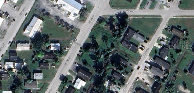 This aerial map view shows residential buildings, streets, and surrounding vegetation in a neighborhood — 609 SW 8TH STREET UNIT 1, BELLE GLADE, FL