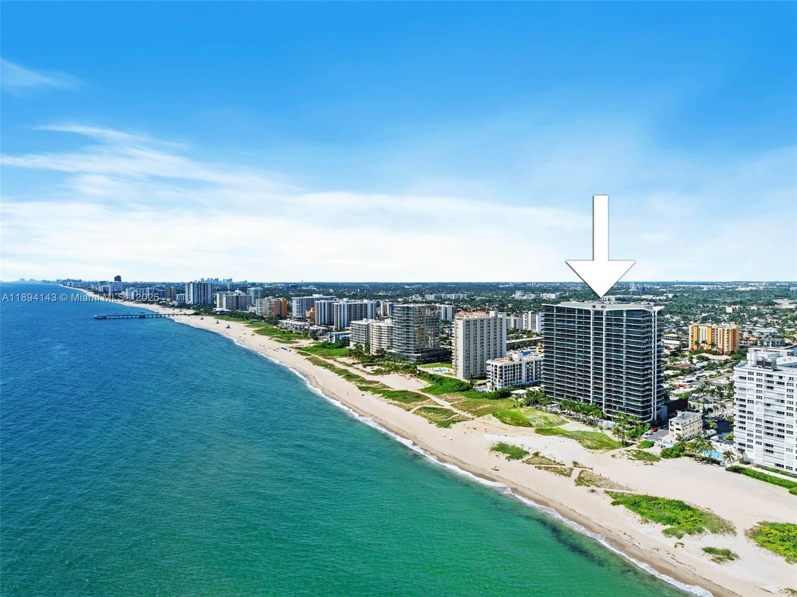 An aerial view shows a high-rise residential building situated along a sandy beach — 900 N Ocean Blvd # 1005, Pompano Beach FL 33062, POMPANO BEACH, FL