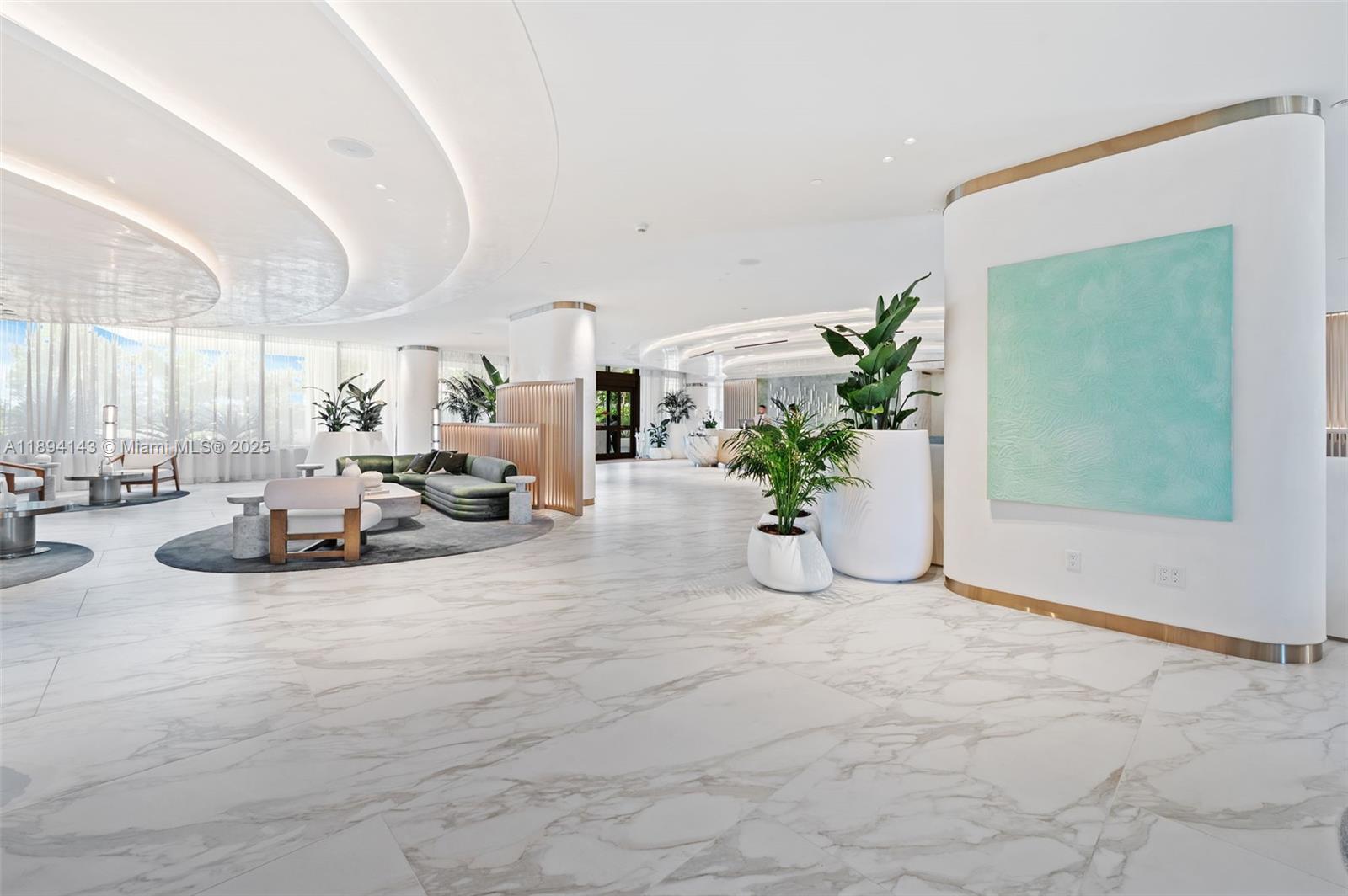 A spacious, modern lobby features marble floors, curved ceilings, and contemporary lounge seating — 900 N Ocean Blvd # 1005, Pompano Beach FL 33062, POMPANO BEACH, FL