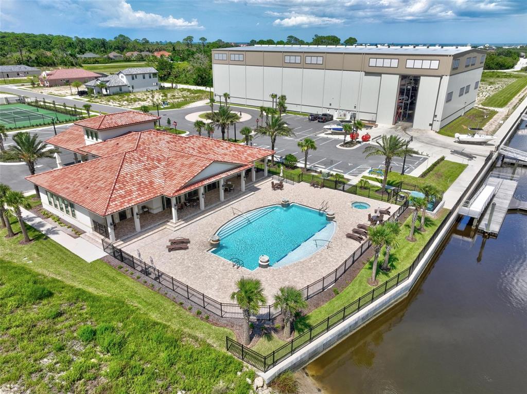 An aerial view of a house with a red tile roof, pool, and adjacent warehouse — 6 DEL PALMA DRIVE, PALM COAST, FL