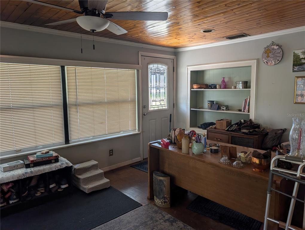 A room with a wood-paneled ceiling, a desk, built-in shelves, and a front door — 4079 LAKE MARIANNA DRIVE, WINTER HAVEN, FL