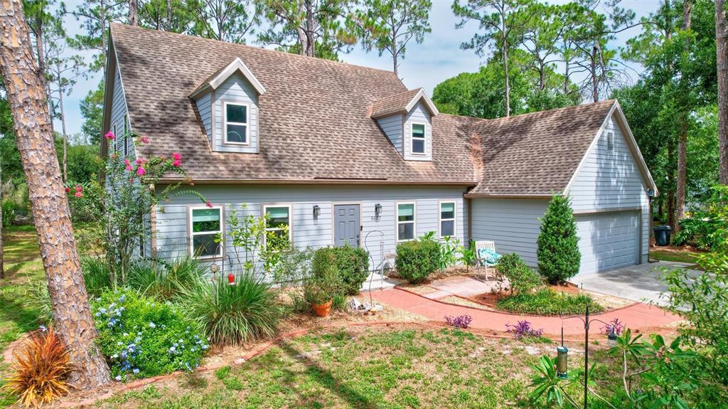 A two-story house with light gray siding, a brown shingled roof, and a front walkway — 9607 OAK RUN DRIVE, BRADENTON, FL