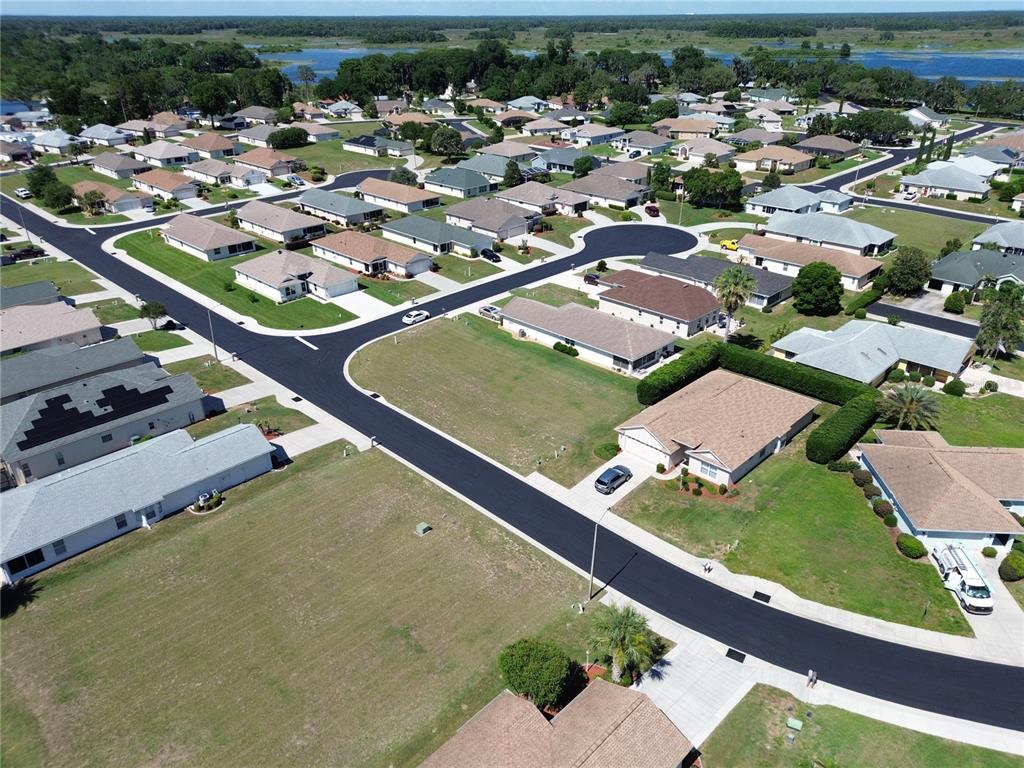 An aerial view shows a suburban neighborhood with single-family homes, paved streets, and green lawns — 3756 E KIWI COVE COURT, HERNANDO, FL