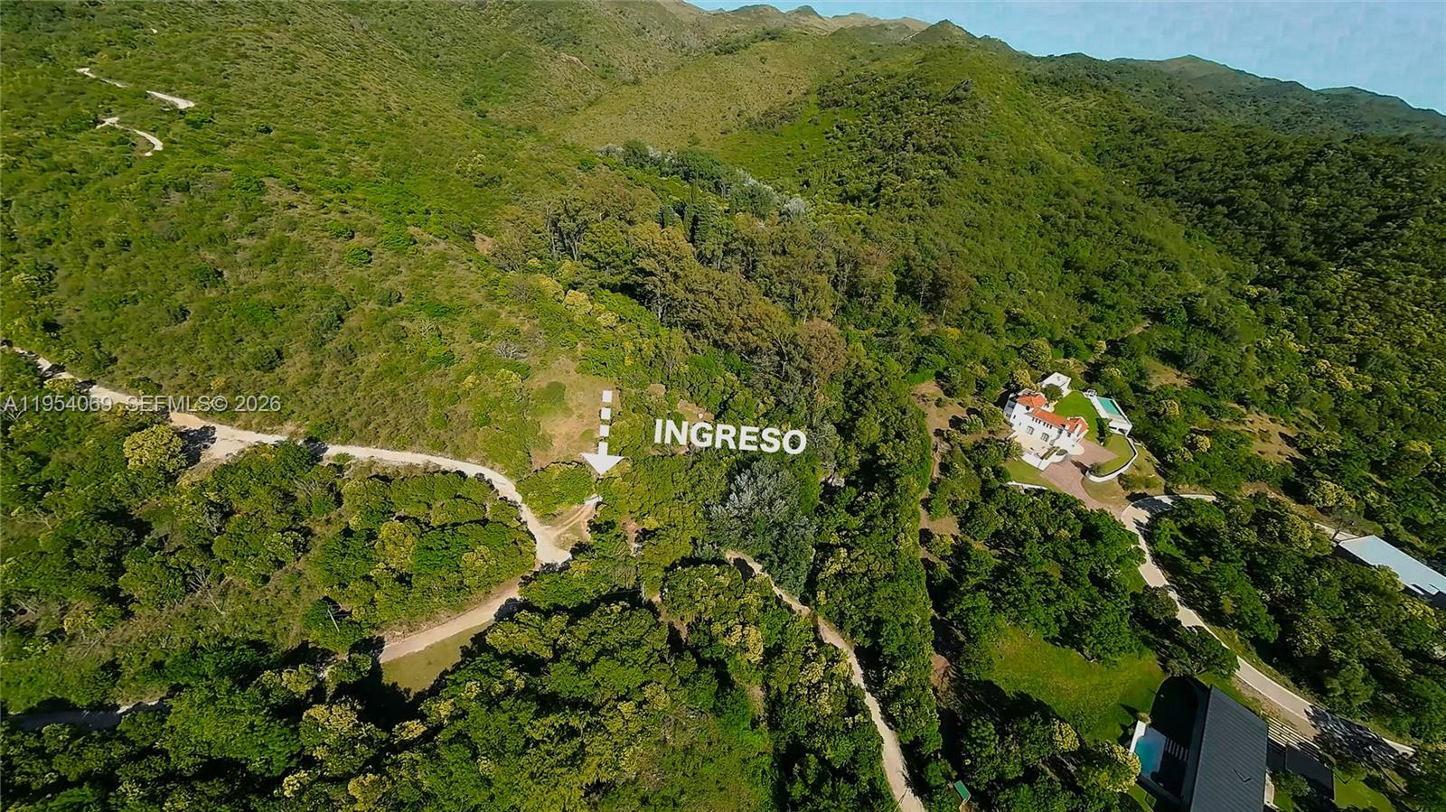 An aerial view shows a rural property with a house, pool, and surrounding forested hills — 1 Segundo Paredon, ALTA GRACIA, 5186, FL