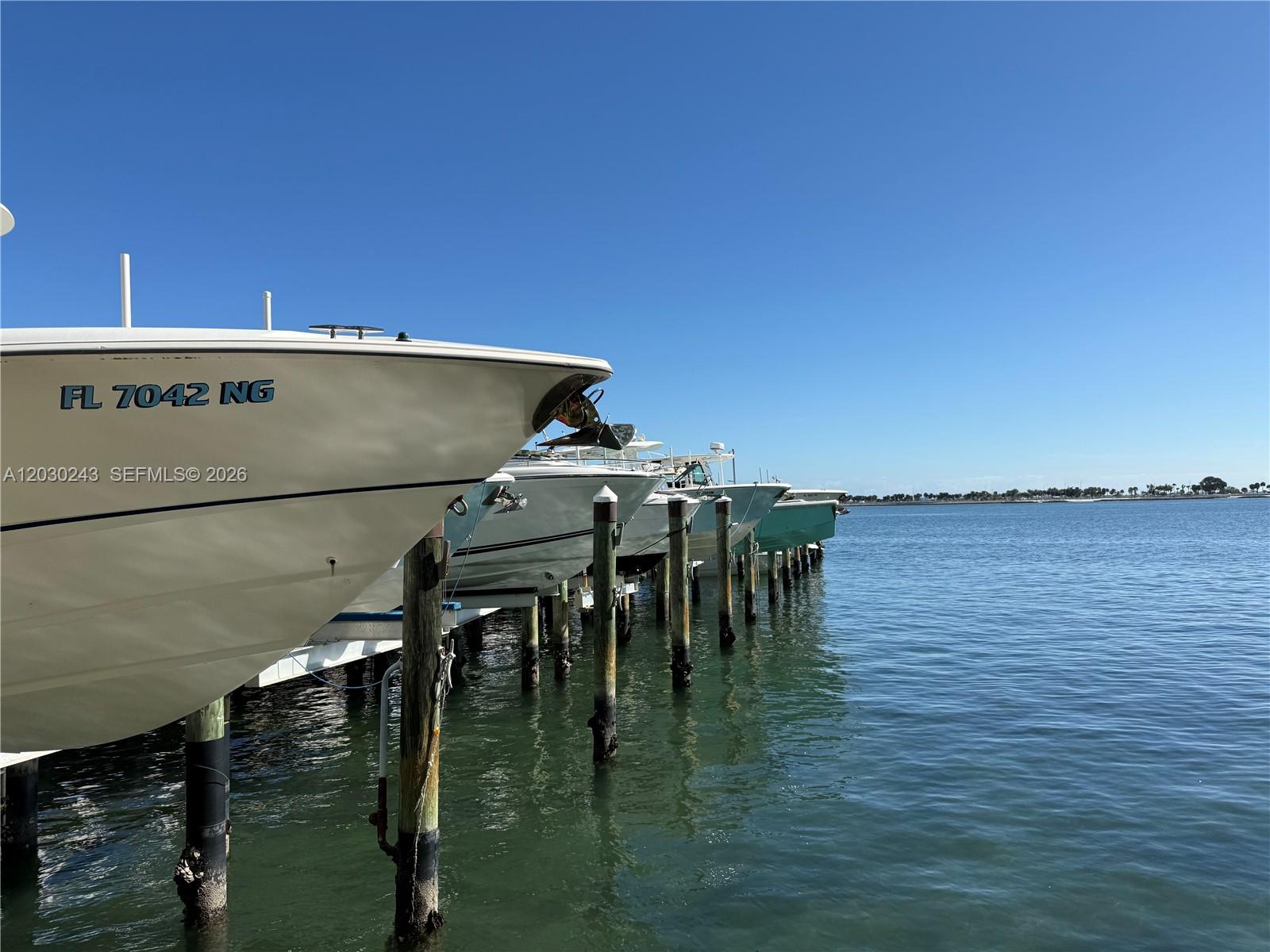 Several boats are docked in a line at a marina on a sunny day — 1925 Brickell Ave # 1403, Miami FL 33129, MIAMI, FL