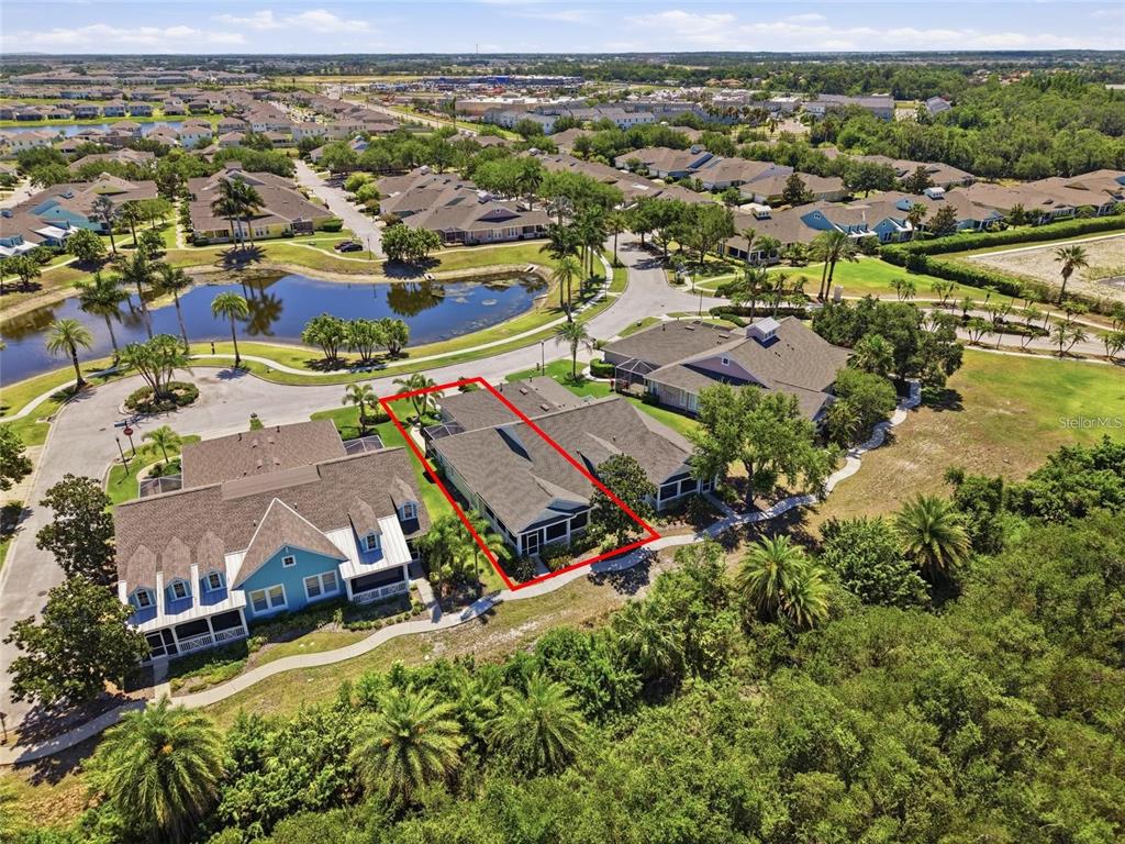 An aerial view shows a residential house outlined in red within a suburban neighborhood — 5610 GOLDEN ISLES DRIVE, APOLLO BEACH, FL