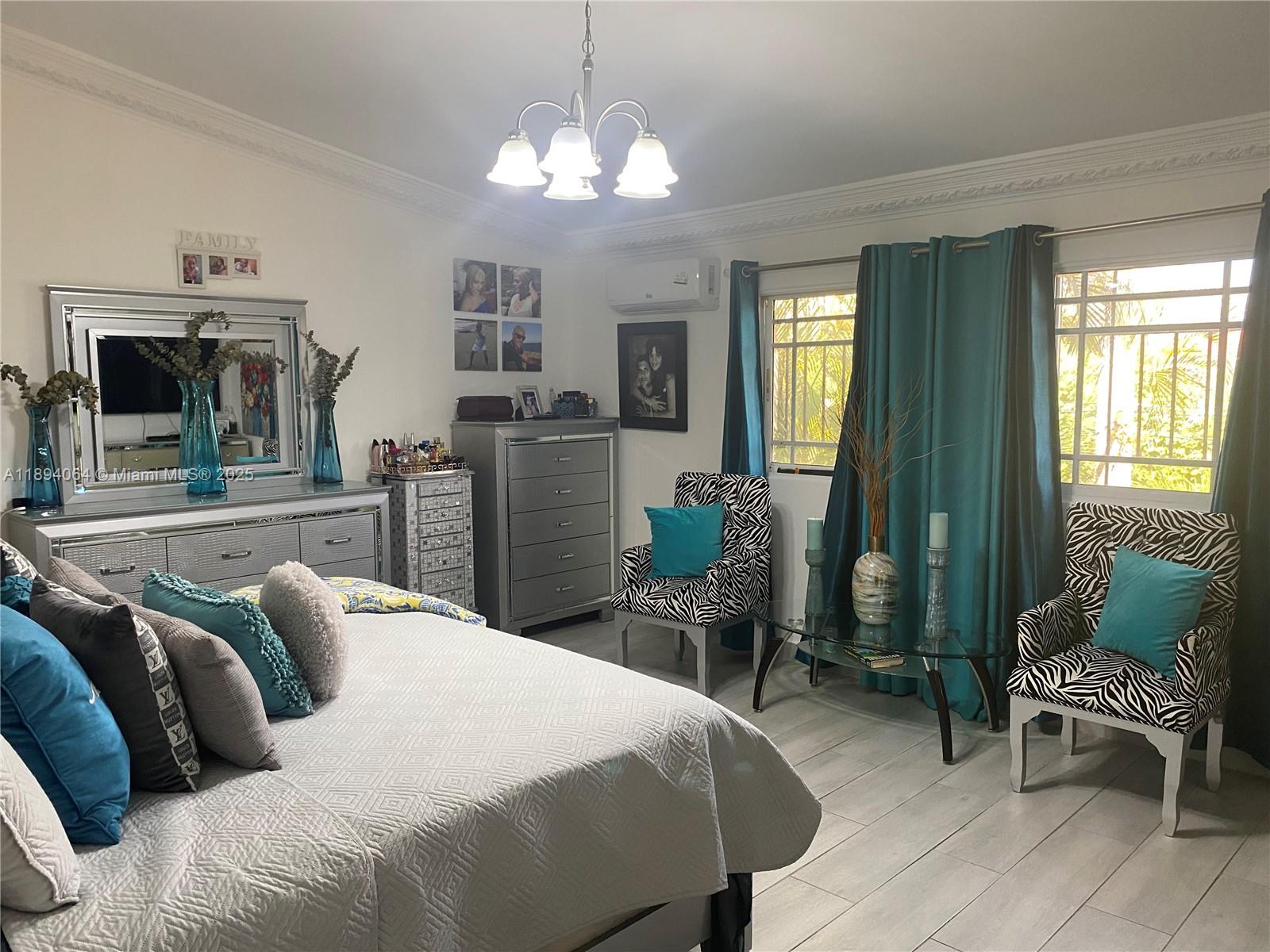 A bedroom features a bed, zebra-print chairs, teal curtains, and silver furniture — 6 CALLE 29 ESTE, NY 10133, NY