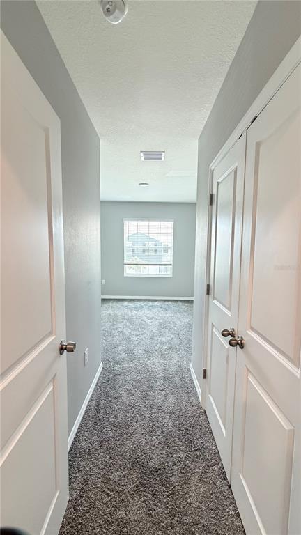 An open-concept kitchen features dark cabinets, granite countertops, and light-colored tile flooring — 5254 DRAGONFLY DRIVE, WILDWOOD, FL
