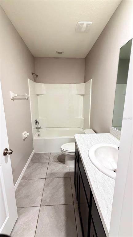 A view through a doorway into a bedroom with gray walls and gray carpeting — 5254 DRAGONFLY DRIVE, WILDWOOD, FL