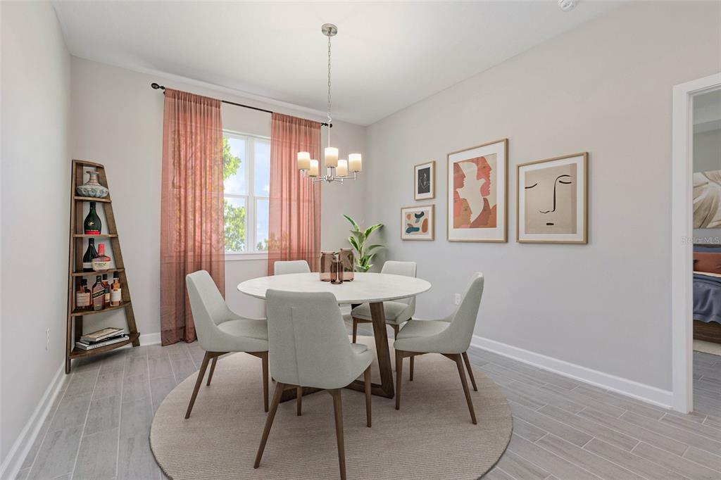 A dining room features a round table, four chairs, a chandelier, and wall art — 789 W HALLAM DR, DUNNELLON, FL