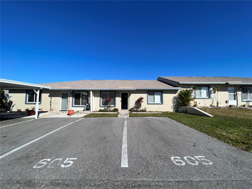 A single-story residential building with two parking spaces marked 605 in the foreground — 605 RIDGE TERRACE UNIT 605, WINTER HAVEN, FL