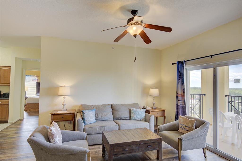 A living room features a gray sofa, two armchairs, a coffee table, and a ceiling fan — 8101 RESORT VILLAGE DRIVE UNIT 31101, ORLANDO, FL