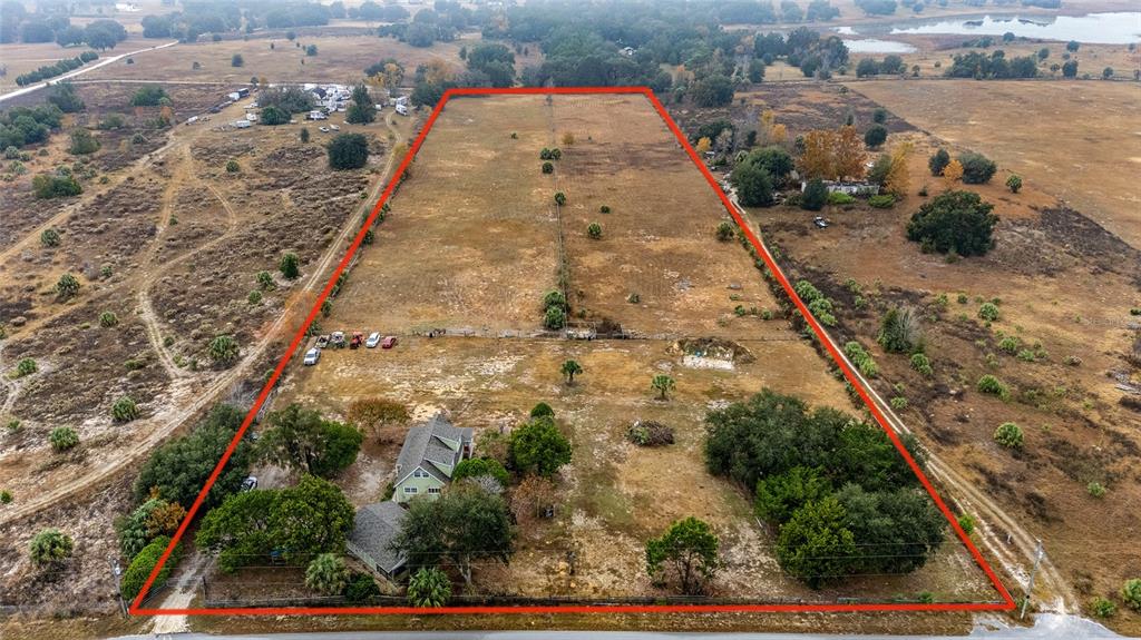 An aerial view shows a house on a large, rectangular plot of land outlined in red — 13590 SE 120TH STREET, DUNNELLON, FL