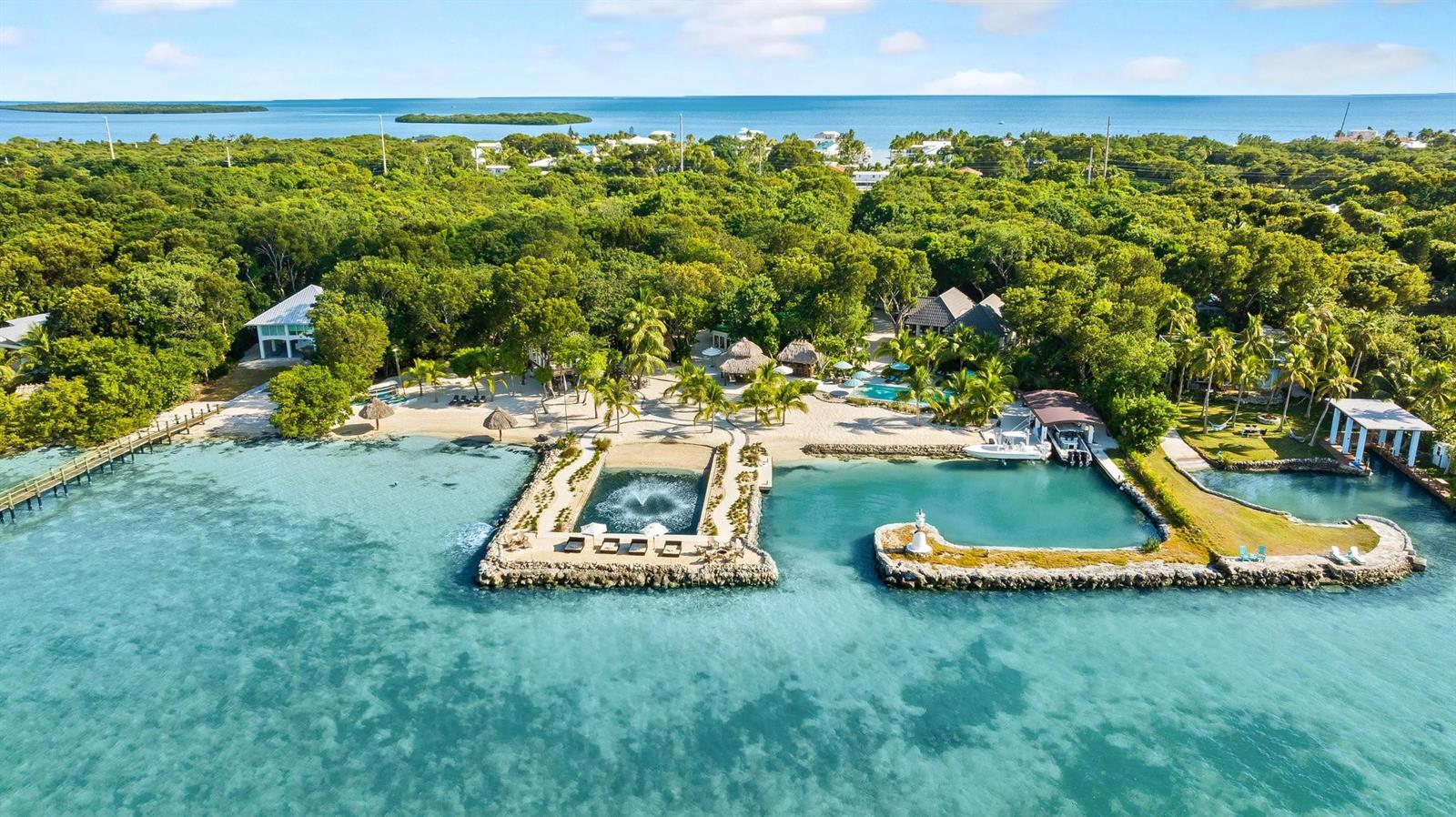 An aerial view of a coastal property featuring a private beach, dock, and swimming pool — 95410 Overseas Highway, Key Largo FL 33037, KEY LARGO, FL
