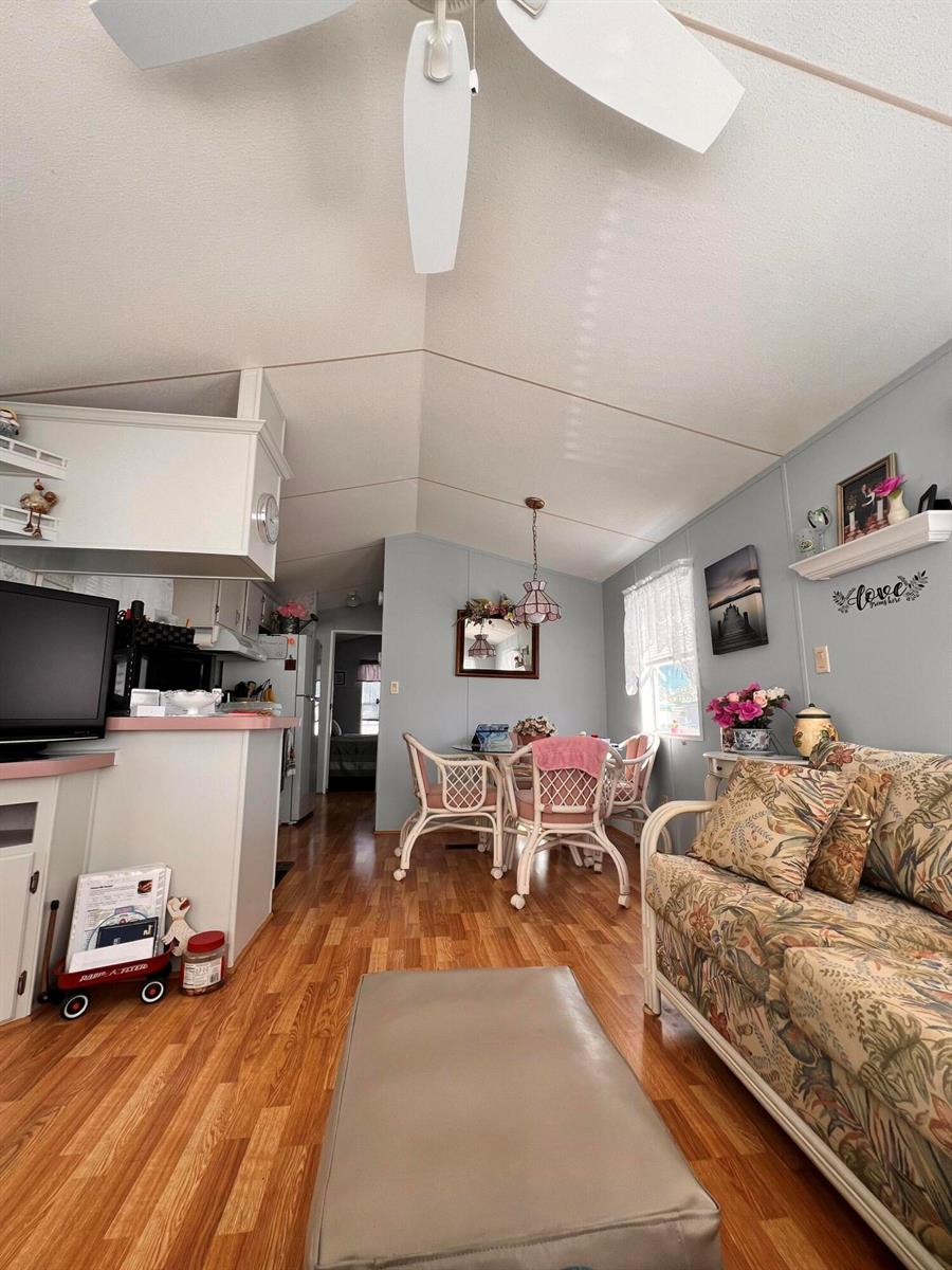 A living room and dining area feature wood-look flooring, a ceiling fan, and floral furniture — 1361 Overseas Highway # G15, Marathon FL 33050, MARATHON, FL