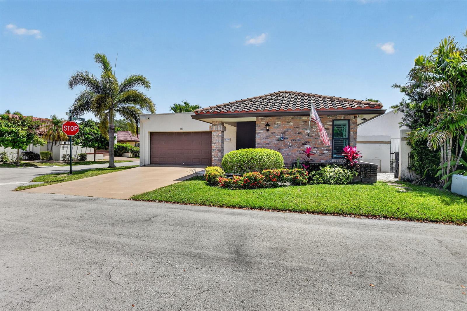 A single-story brick house with a tile roof, garage, and landscaped front yard — 6790 Jardin Place, Boca Raton FL 33433, BOCA RATON, FL