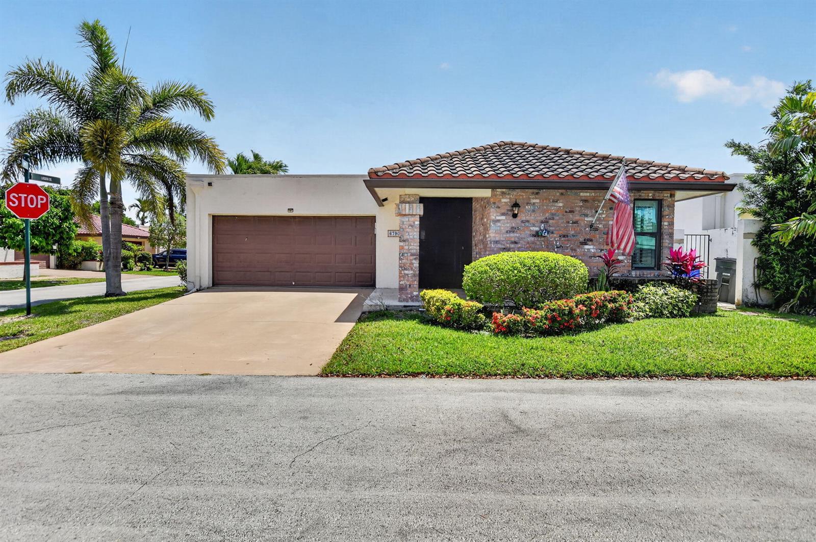 A single-story brick house with a tile roof, garage, and front yard under a blue sky — 6790 Jardin Place, Boca Raton FL 33433, BOCA RATON, FL