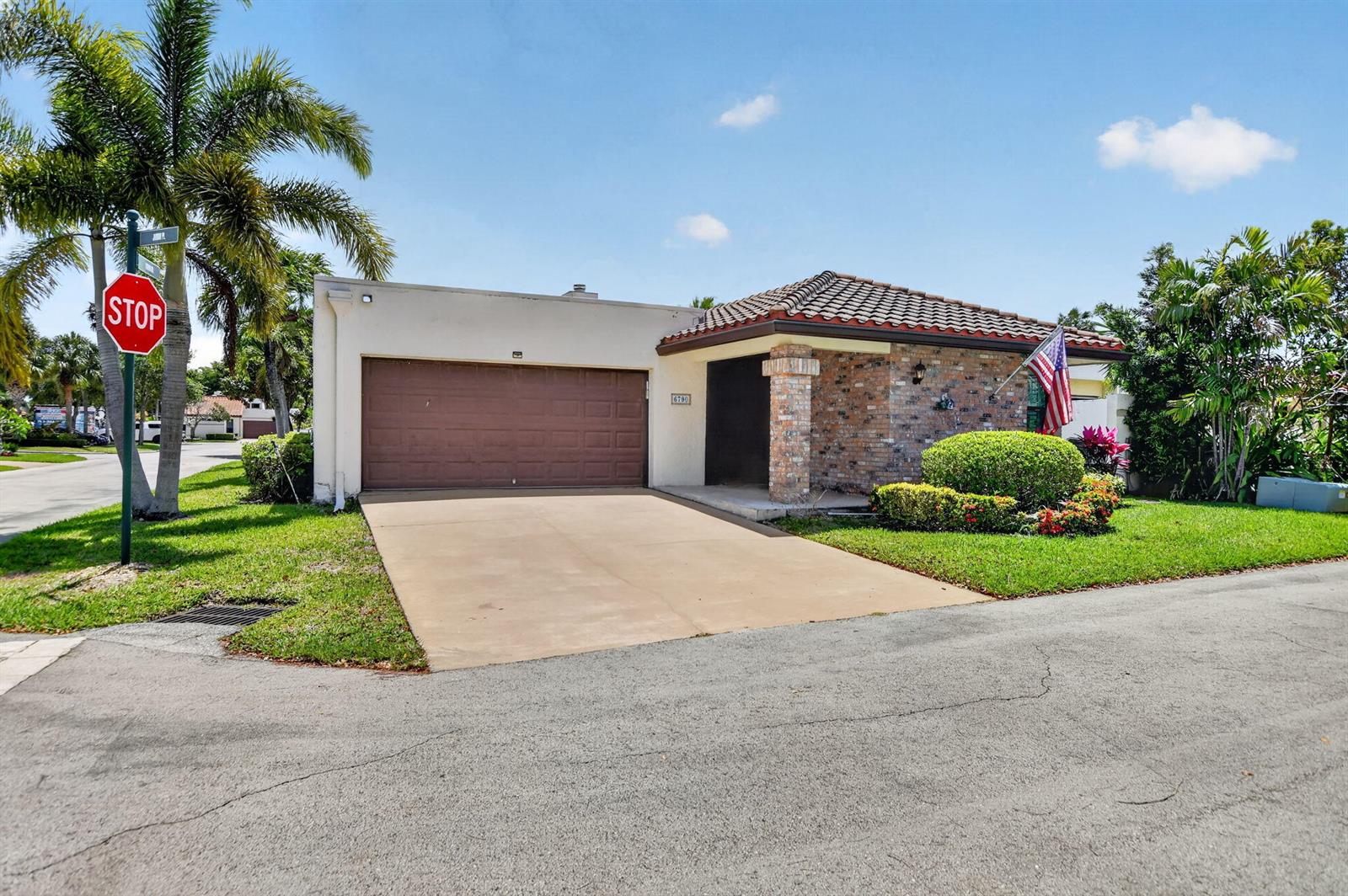 A single-story house with a brick facade, tile roof, and a brown garage door — 6790 Jardin Place, Boca Raton FL 33433, BOCA RATON, FL
