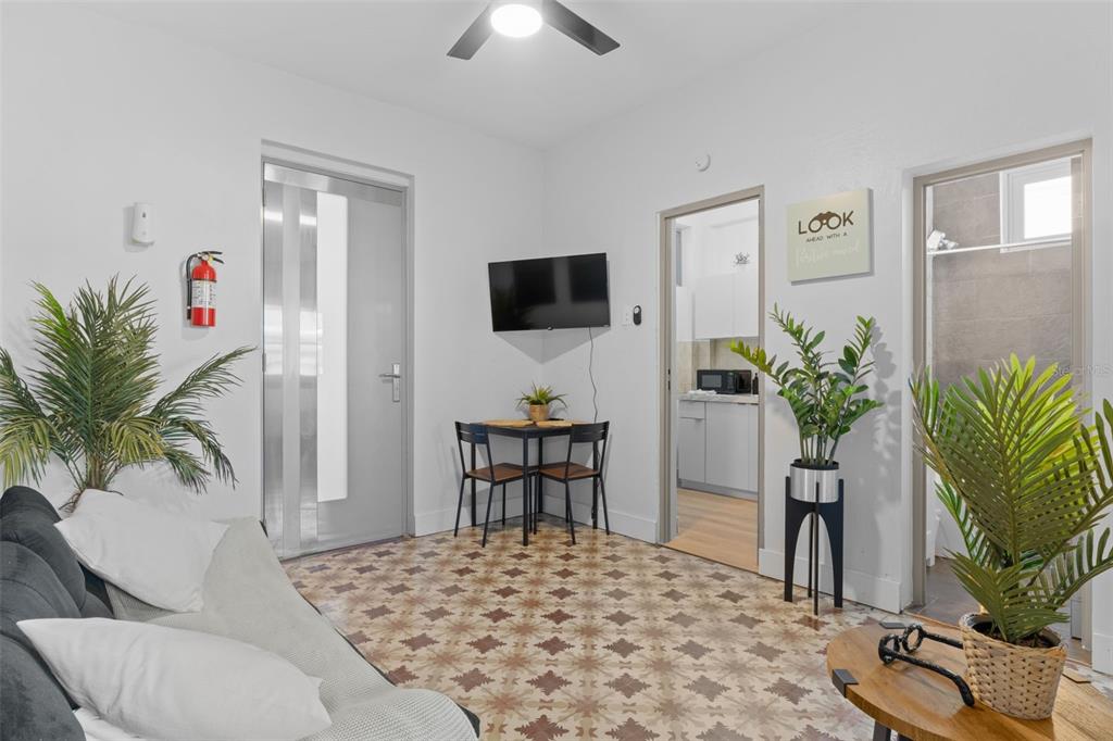 A living room features patterned tile flooring, a dining set, and a wall-mounted television — 261 DUFFAUNT, SAN JUAN, PR