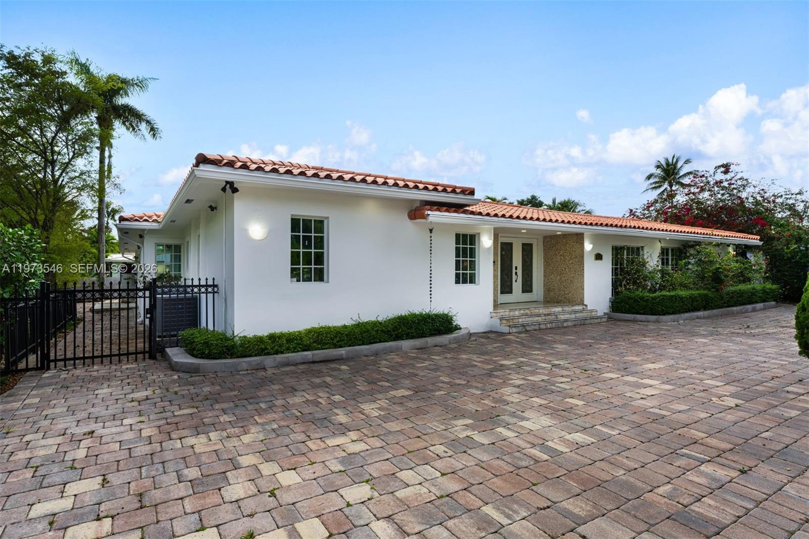 A single-story house with a white exterior, red tile roof, and a paved driveway — 400 SW 24th Rd, Miami FL 33129, MIAMI, FL