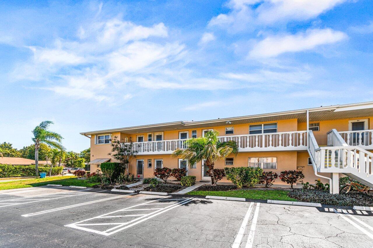 A two-story apartment building with a parking lot, white railings, and palm trees — 2121 NE 1st Court # 202, Boynton Beach FL 33435, BOYNTON BEACH, FL