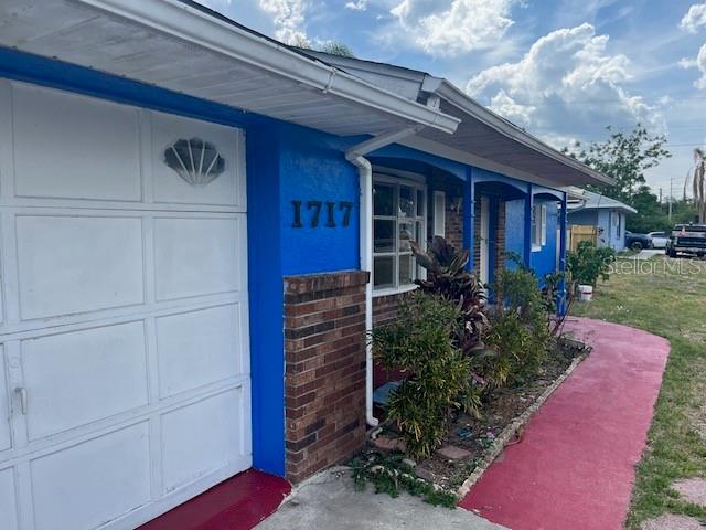 A blue exterior wall with the house number 1717 and a white garage door — 1717 STATE ROAD 17 N, SEBRING, FL