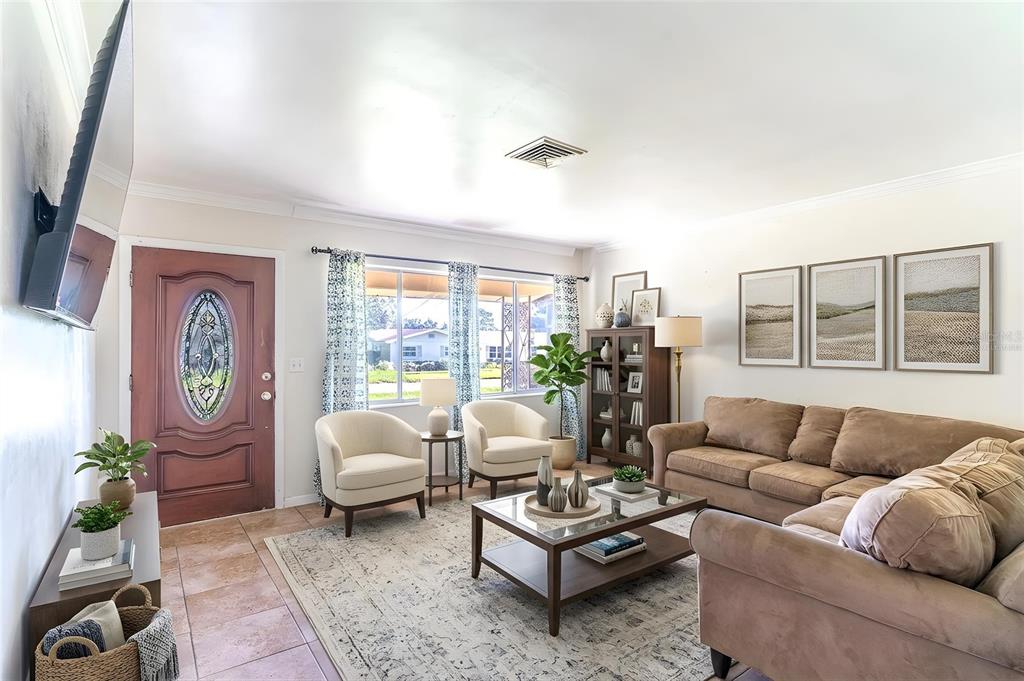 A living room features a brown sectional sofa, two cream armchairs, and a glass coffee table — 1500 AVENUE H NE, WINTER HAVEN, FL