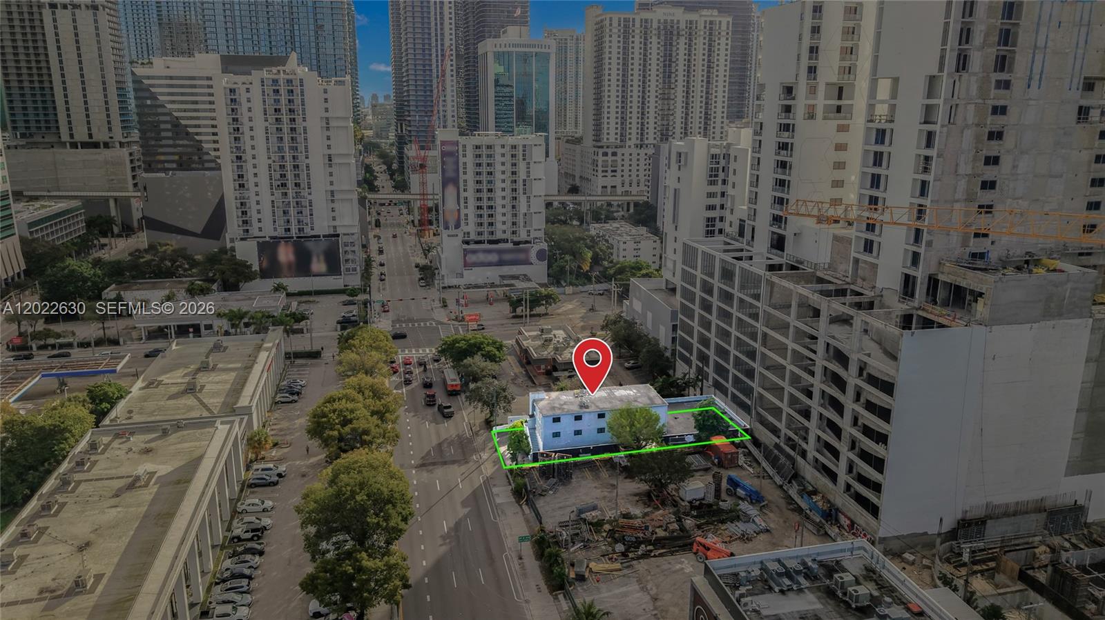 An aerial view shows a small blue building outlined in green amidst urban high-rise construction — 232 SW 8th St, Miami FL 33130, MIAMI, FL