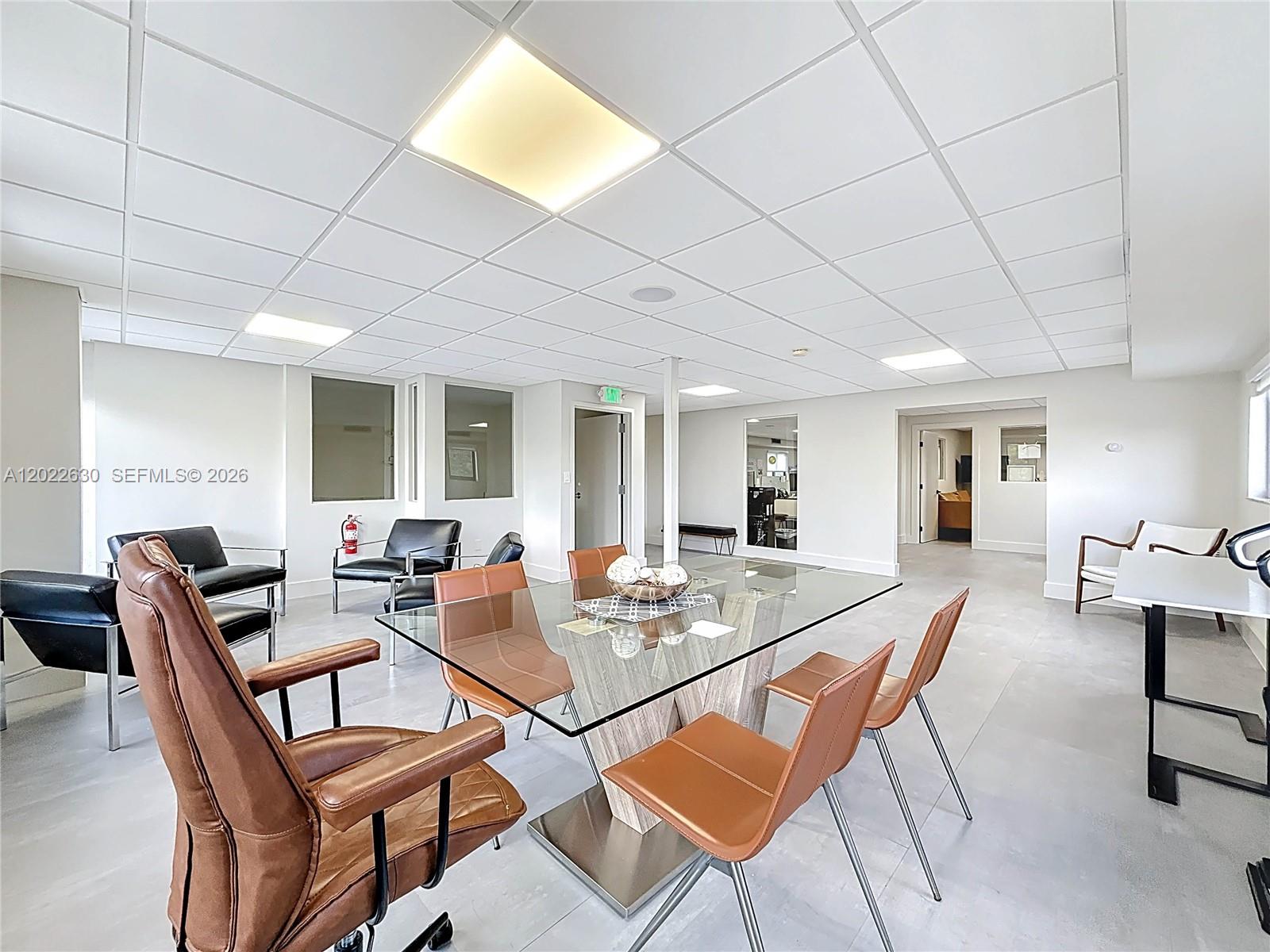 A modern office conference room features a glass table, leather chairs, and a drop ceiling — 232 SW 8th St, Miami FL 33130, MIAMI, FL