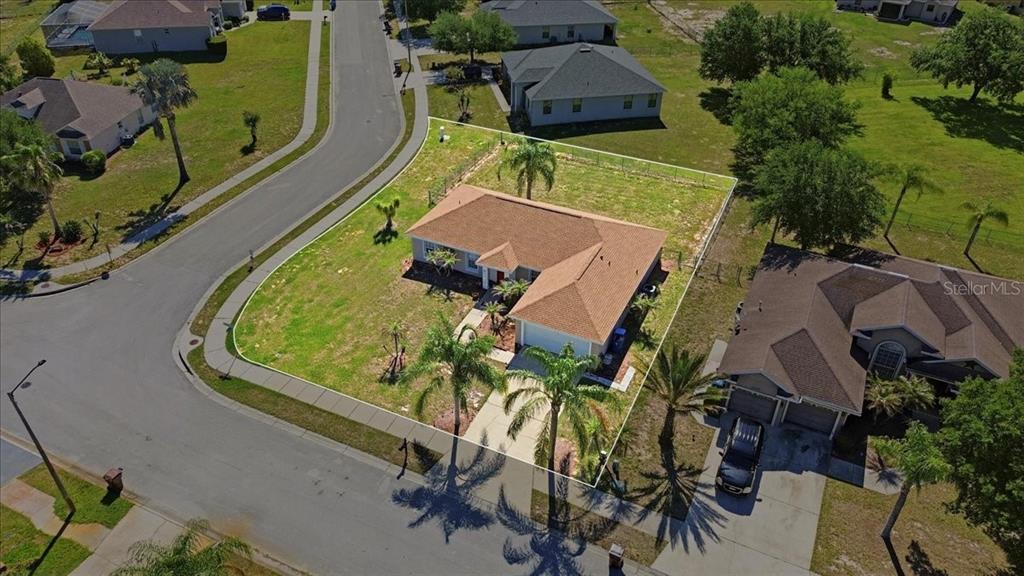 An aerial view shows a single-story house with a brown roof on a corner lot — 4378 DINNER LAKE BOULEVARD, LAKE WALES, FL