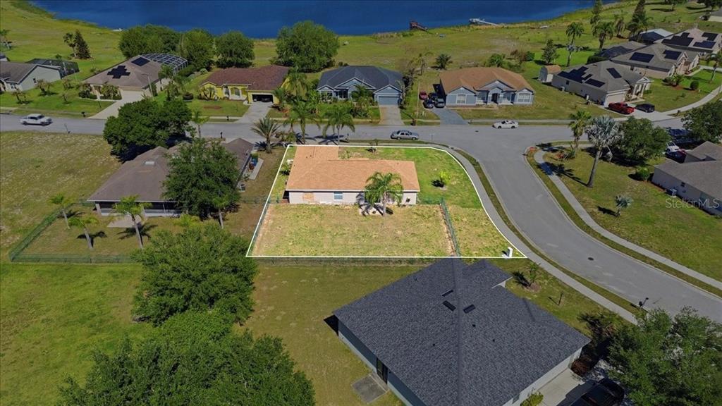 An aerial view shows a single-story house with a fenced yard on a corner lot — 4378 DINNER LAKE BOULEVARD, LAKE WALES, FL