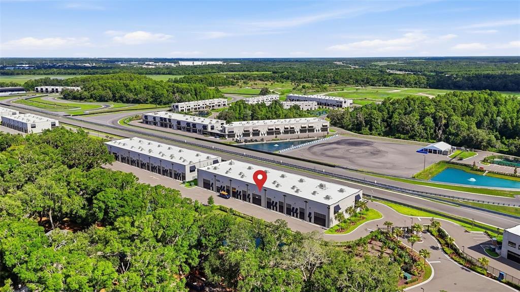 An aerial view shows a modern commercial building complex with a red location pin — 6500 MOTOR ENCLAVE WAY UNIT 814, TAMPA, FL