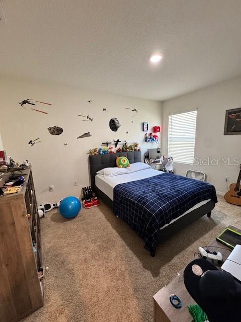 A bedroom features a bed with a blue plaid comforter and Star Wars wall decals — 414 COOL SUMMER LANE, DAVENPORT, FL