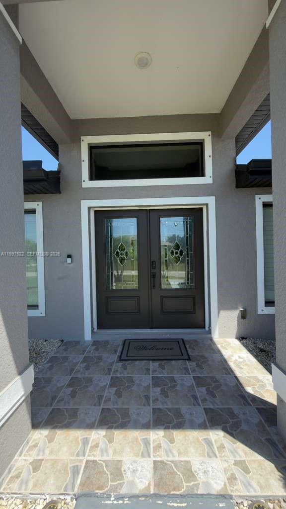 The exterior entryway features a double door with glass inserts and a tiled porch floor — 4407 SW 16th PL, Cape Coral FL 33914, CAPE CORAL, FL