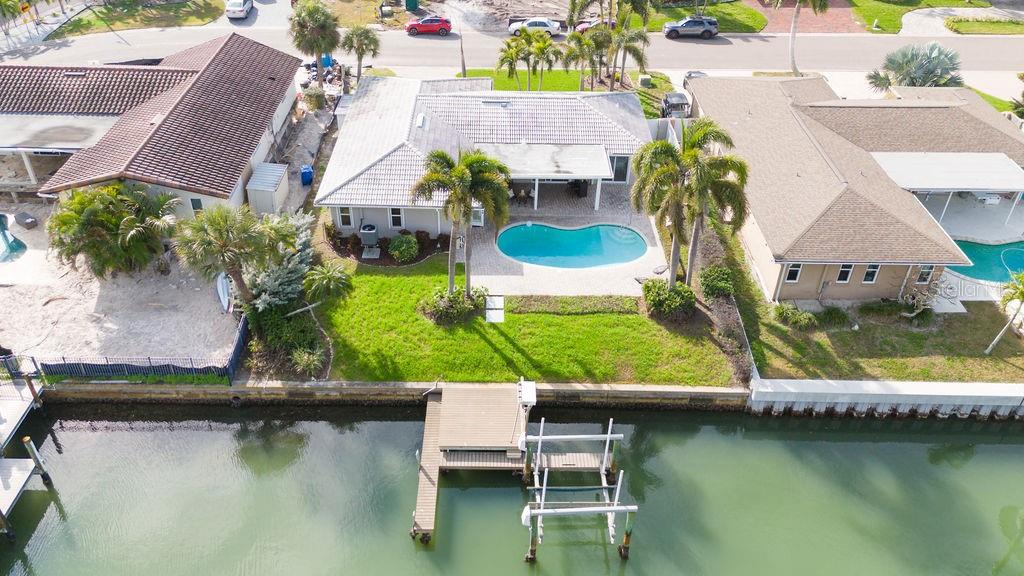 An aerial view of a waterfront house with a swimming pool and a private dock — 3807 48TH AVENUE S, ST PETERSBURG, FL