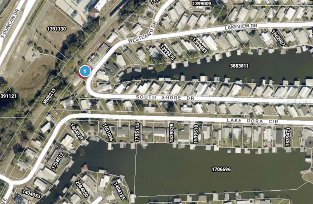 This is an aerial map view showing residential properties along a canal and streets — 0 WESTLAND DRIVE, TAVARES, FL