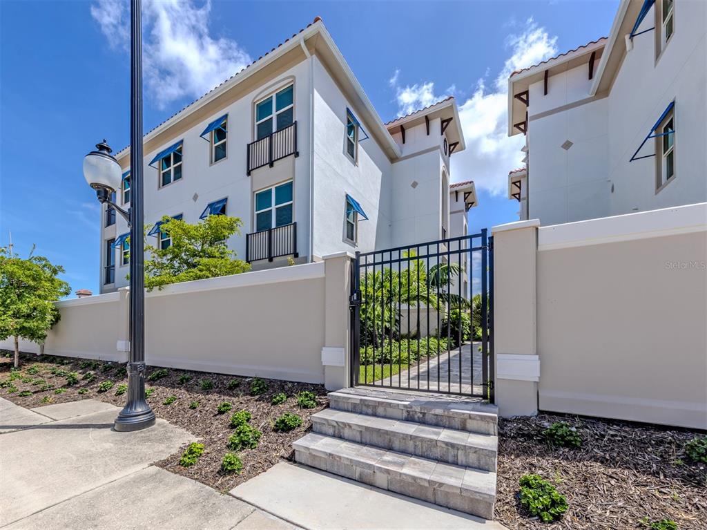 A row of residential garages with tan doors and a red tile roof under blue skies — 787 S.  TAMIAMI TRAIL UNIT 103, VENICE, FL