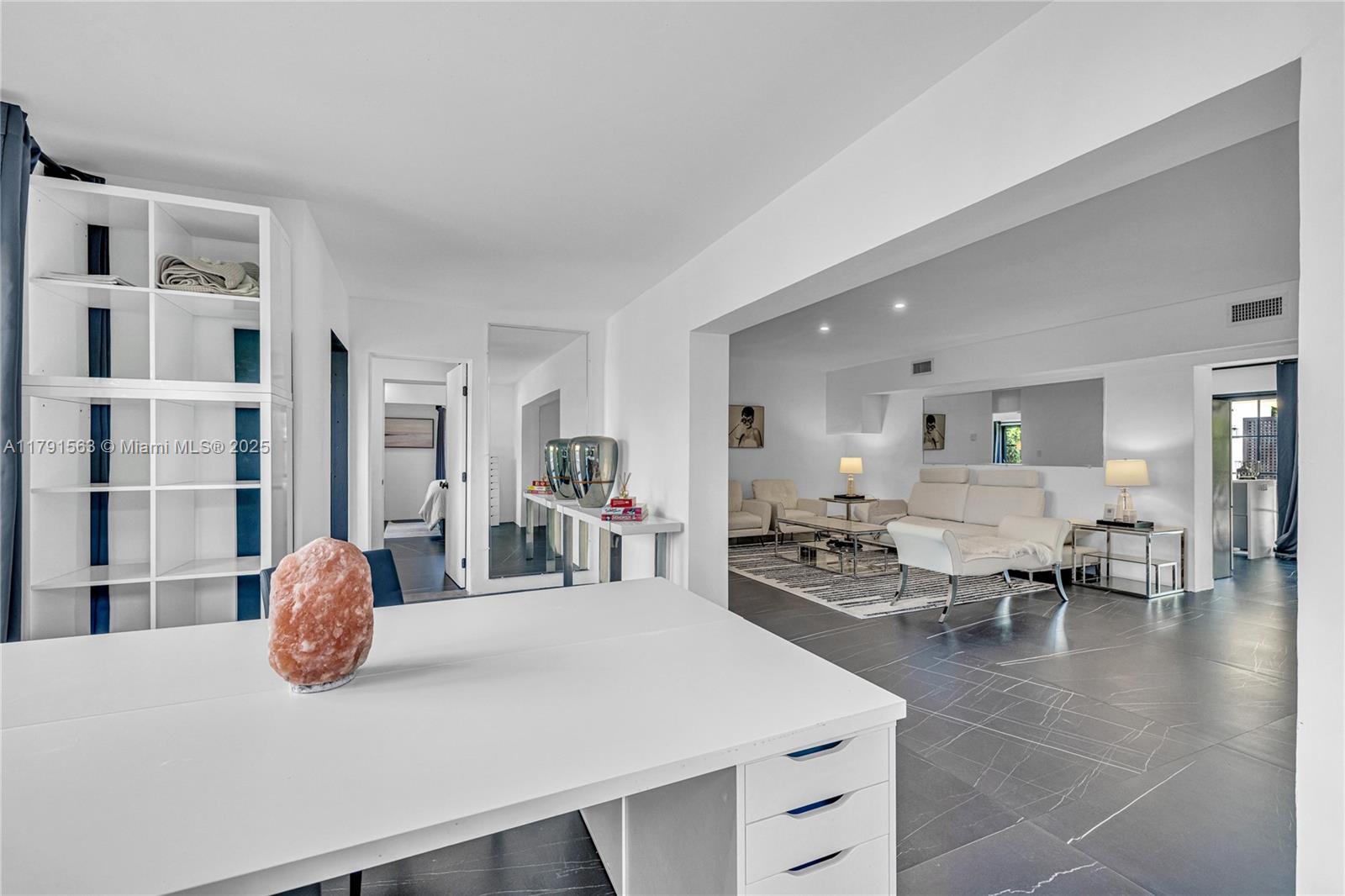 A white desk with a salt lamp sits in a room with dark tiled floors — 560 NW 116th Ter, Miami FL 33168, MIAMI, FL