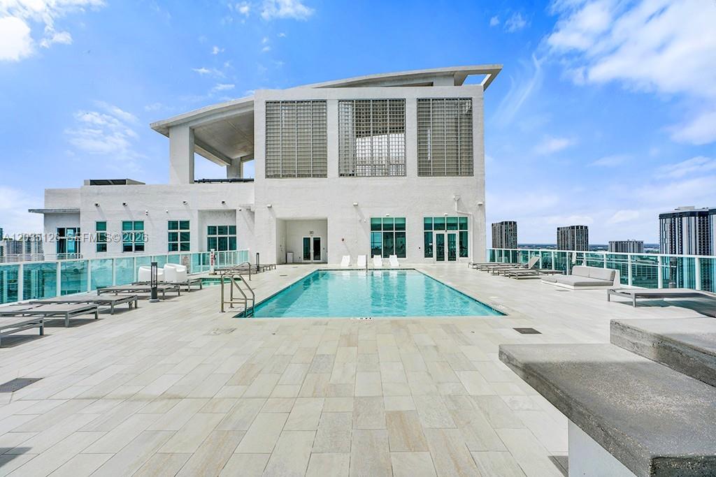 A rooftop swimming pool is surrounded by a tiled deck and lounge chairs — 133 NE 2nd Ave # 1013, Miami FL 33132, MIAMI, FL